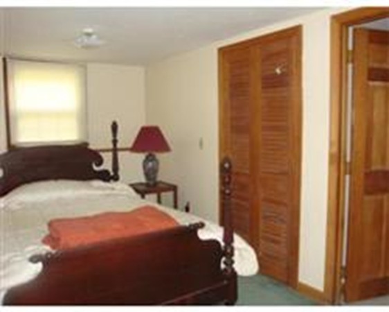 419 Wares Road Ashby, MA 01431 - Photo 20 of 21 a bedroom with a bed and a chandelier