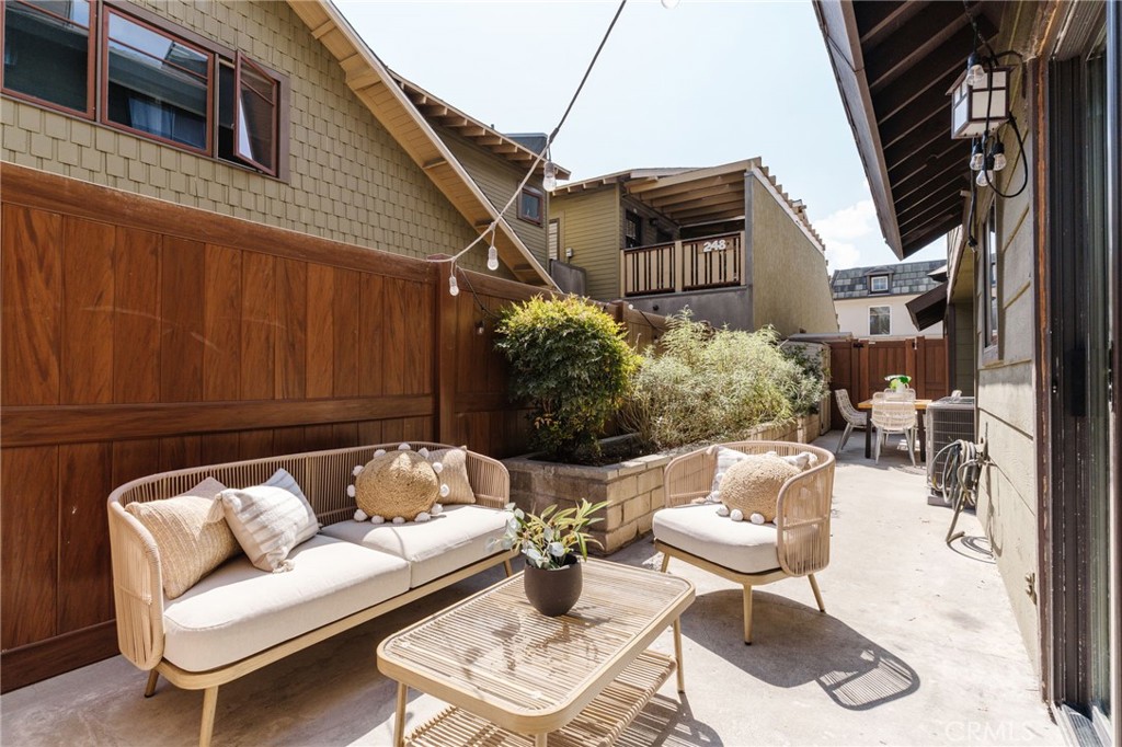 246 Alpine Street, Unit 5 Pasadena, CA 91106 - Photo 23 of 26 a view of a patio with couches table and chairs and potted plants