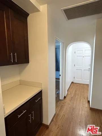 a view of hallway with wooden floor