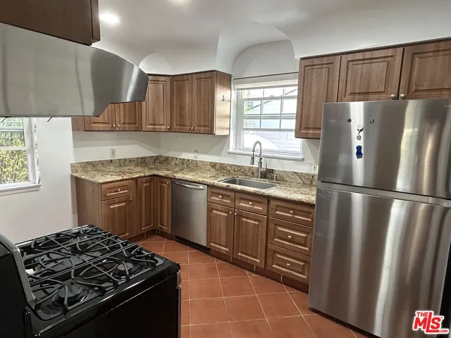 a kitchen with a sink stove and refrigerator