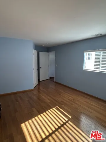 a view of wooden floor and windows in a room