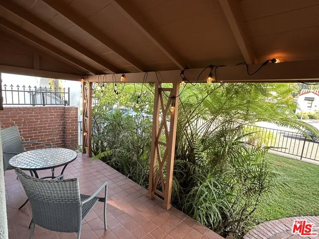 a view of a porch with furniture and a yard