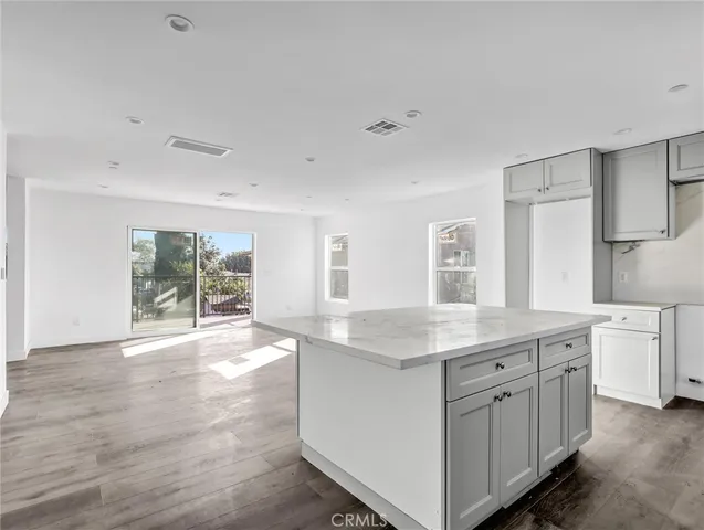 a kitchen with cabinets and window