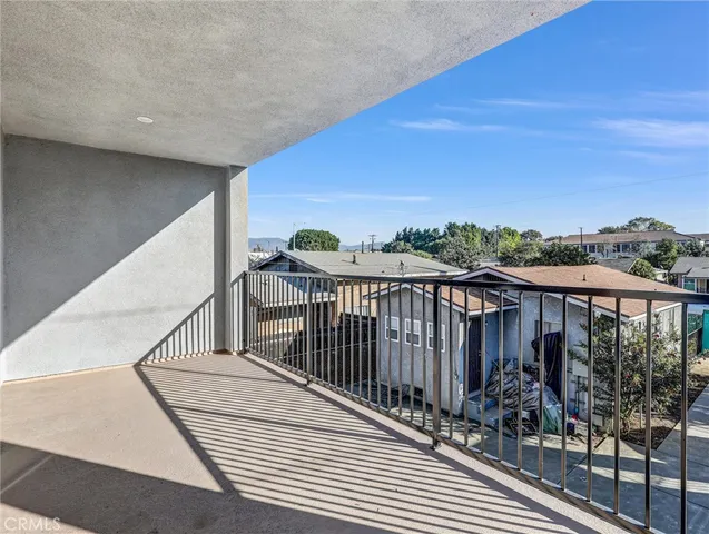 a view of a balcony with wooden floor and city view