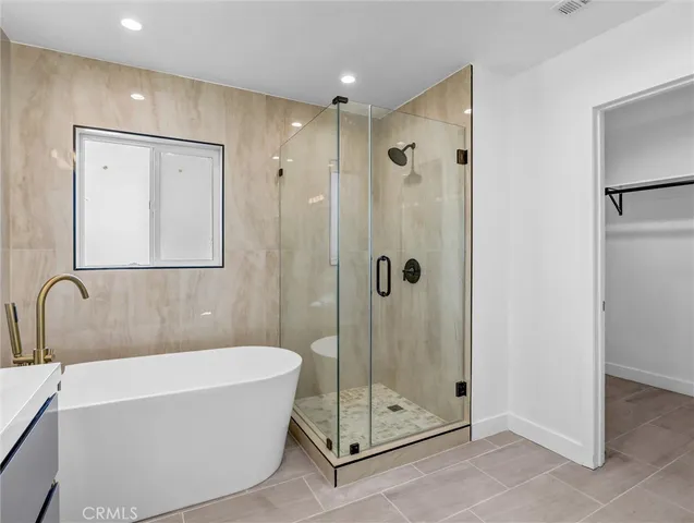 a bathroom with a bathtub and a shower