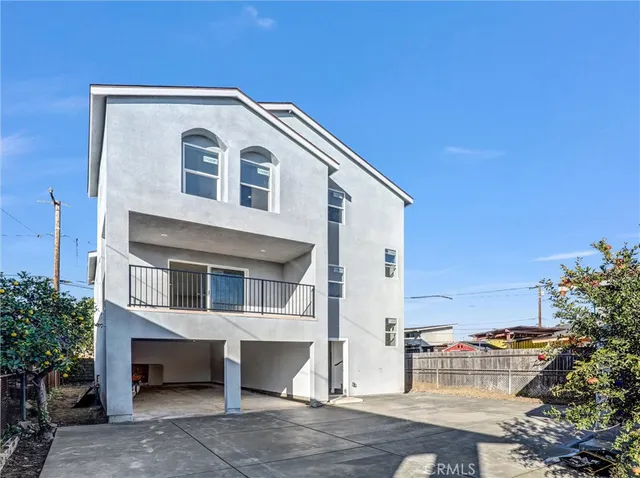 a view of a white house with a outdoor space