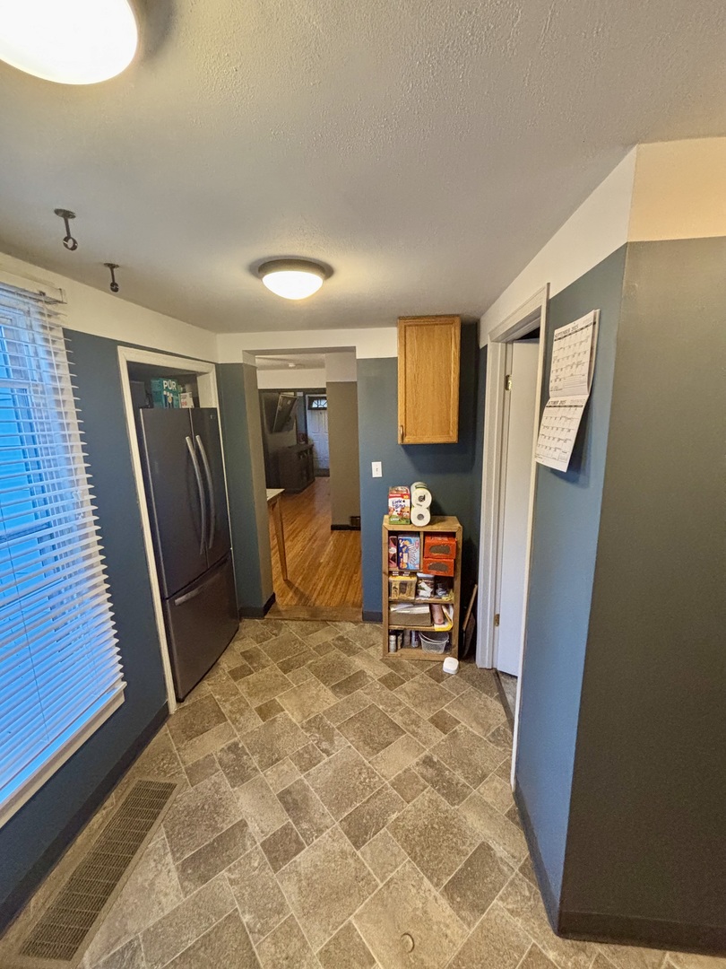 1410 3rd Avenue Sterling, IL 61081 - Photo 4 of 13 a bed room with a chair and a large mirror