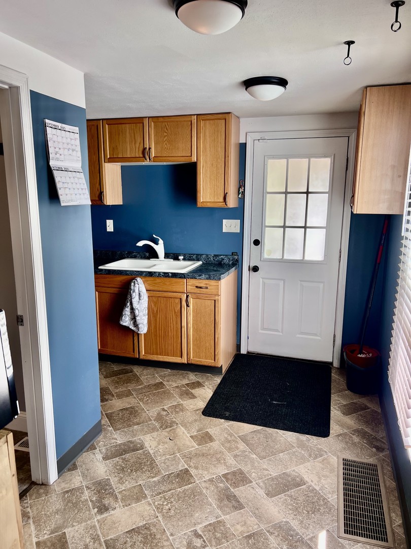 1410 3rd Avenue Sterling, IL 61081 - Photo 6 of 13 a kitchen with granite countertop a sink and a stove
