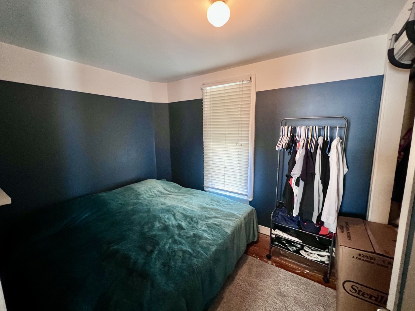 1410 3rd Avenue Sterling, IL 61081 - Photo 10 of 13 a bedroom with a bed and a flat tv screen on a dresser