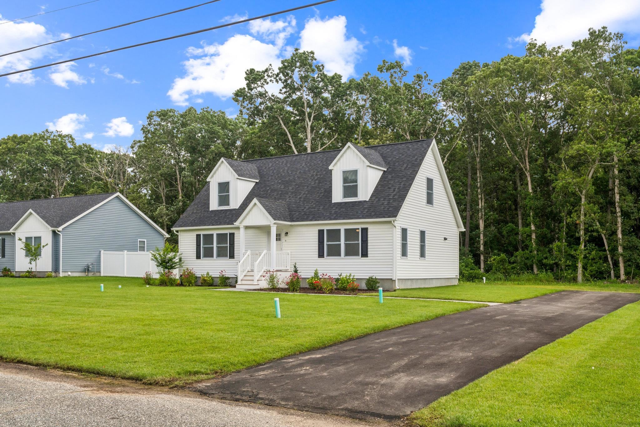 70 West Rising Sun Drive Ocean View, NJ 08230 - Photo 3 of 34 a front view of a house with a garden and trees