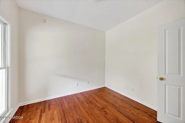 an empty room with wooden floor