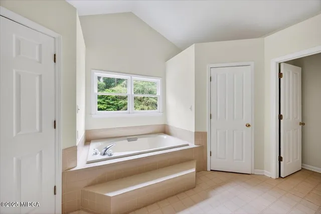 a view of bathroom with bathtub and shower