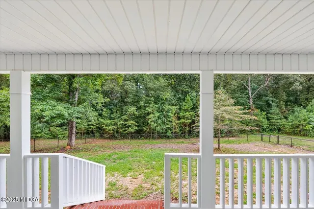 a view of a back yard from a balcony