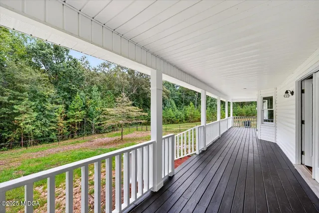 a view of balcony with wooden floor