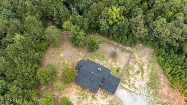 an aerial view of a house with yard