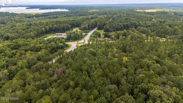 a view of a green field with an outdoor space