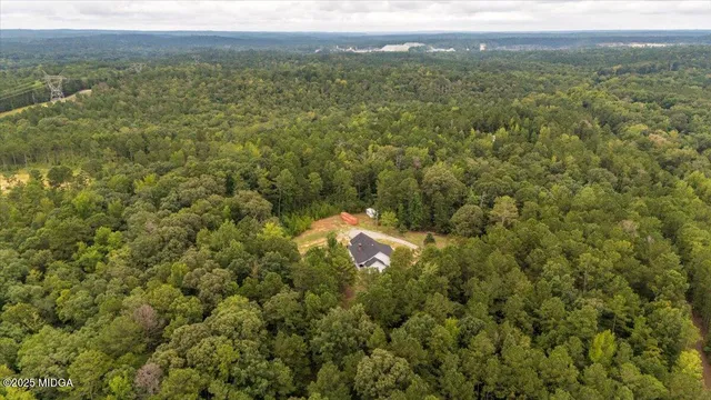 an aerial view of a house with a yard