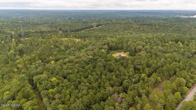 an aerial view of a house with a yard table and chairs