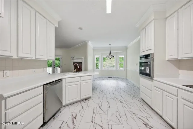 a kitchen with stainless steel appliances a sink dishwasher stove refrigerator and cabinets