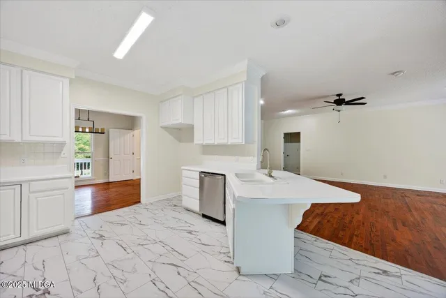 a large white kitchen with cabinets