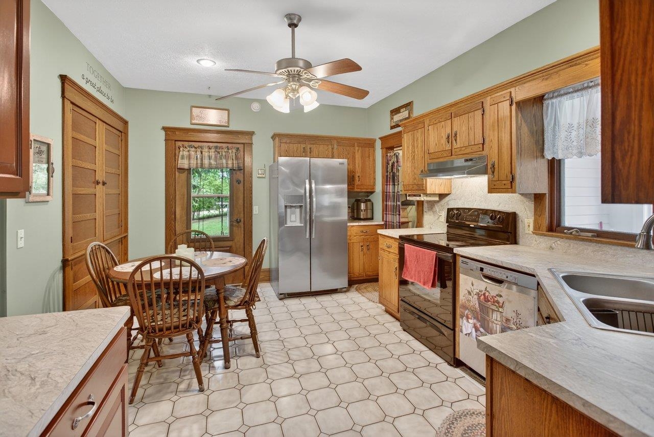 107 Timber Way Broadway, VA 22815 - Photo 15 of 73 a open kitchen with stainless steel appliances granite countertop a stove a refrigerator a sink dishwasher a dining table and chairs with wooden floor