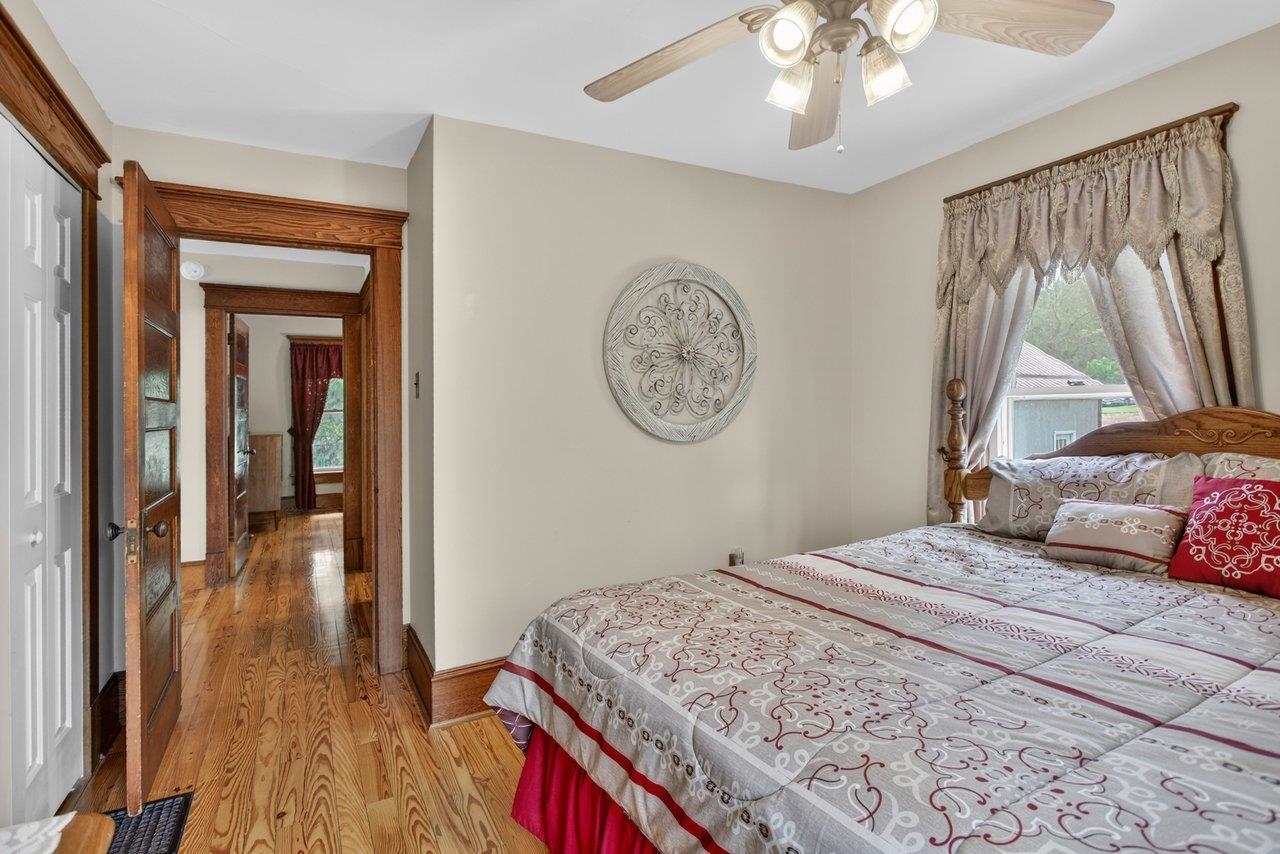 107 Timber Way Broadway, VA 22815 - Photo 34 of 73 a bedroom with a large bed and a chandelier