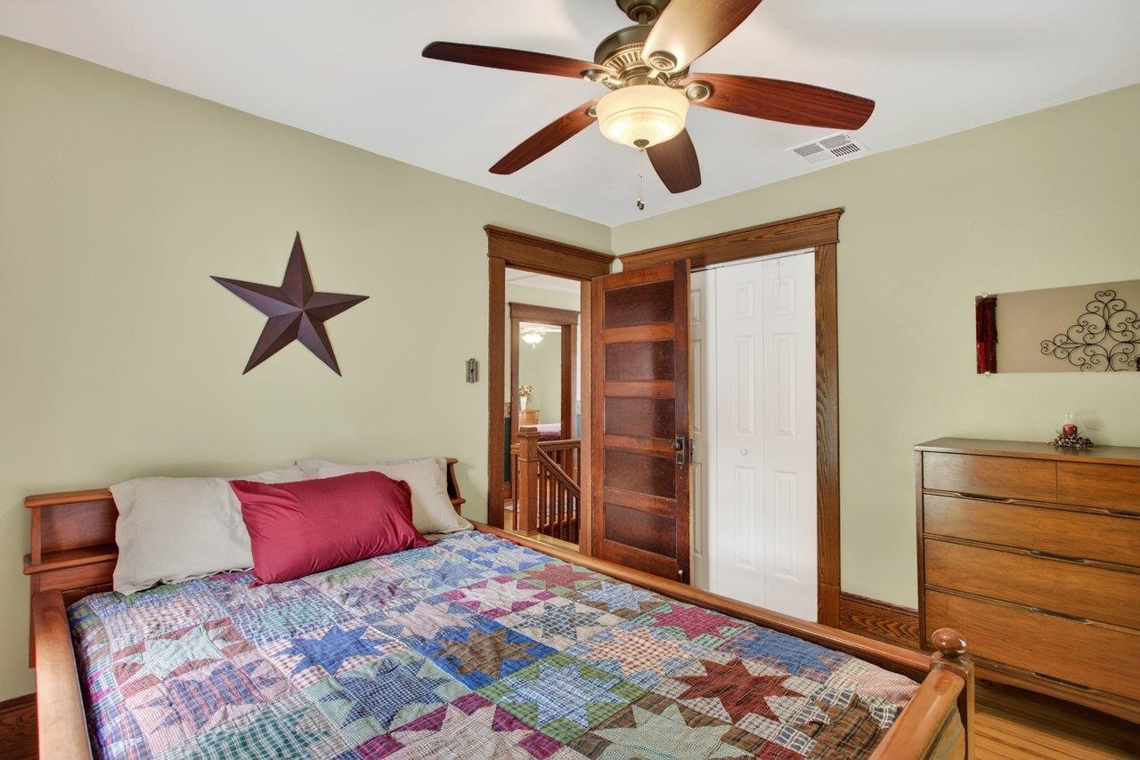 107 Timber Way Broadway, VA 22815 - Photo 39 of 73 a bedroom with a bed and a chandelier