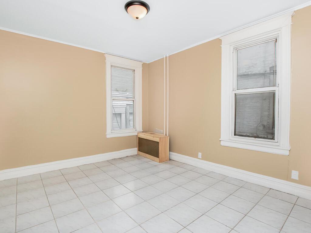3357 Perry Avenue Bronx, NY 10467 - Photo 15 of 31 Empty room featuring ornamental molding and baseboards