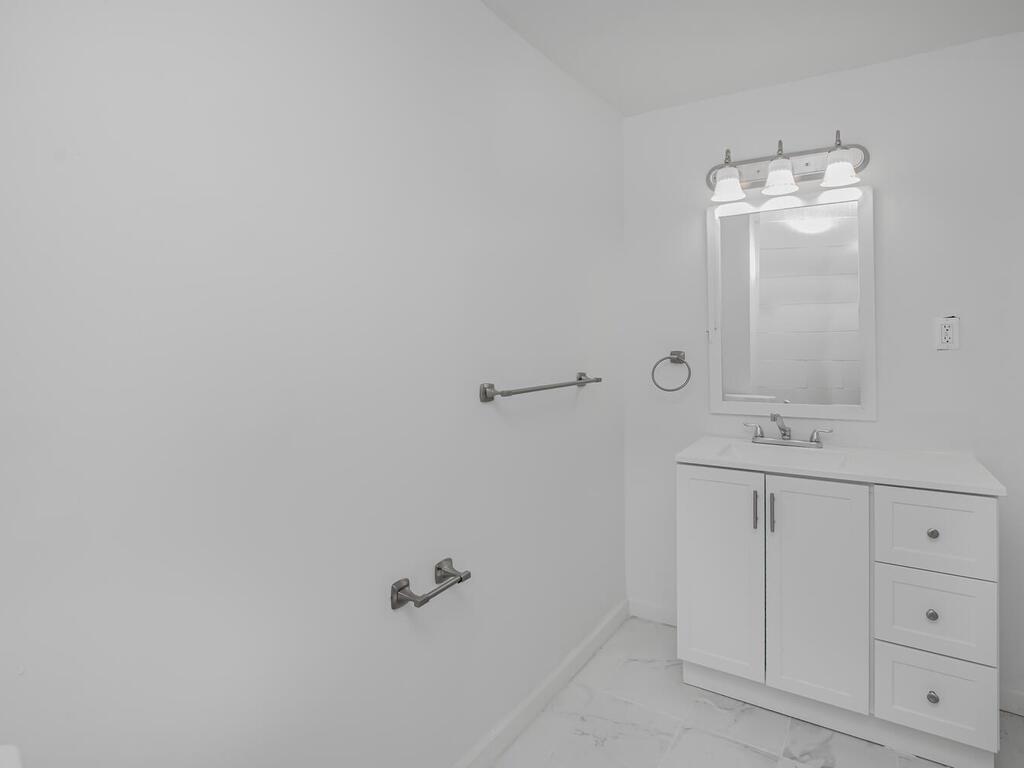 3357 Perry Avenue Bronx, NY 10467 - Photo 18 of 31 Bathroom featuring marble finish floor, vanity, and baseboards