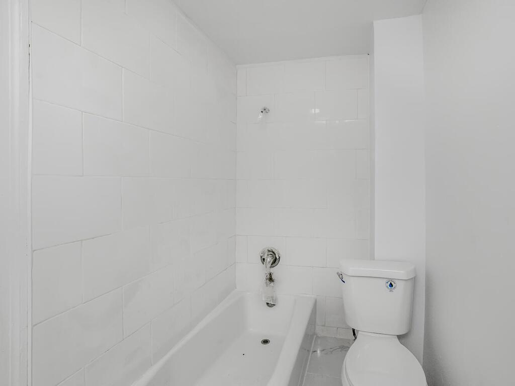3357 Perry Avenue Bronx, NY 10467 - Photo 19 of 31 Full bath featuring toilet, a bath, and walk in shower