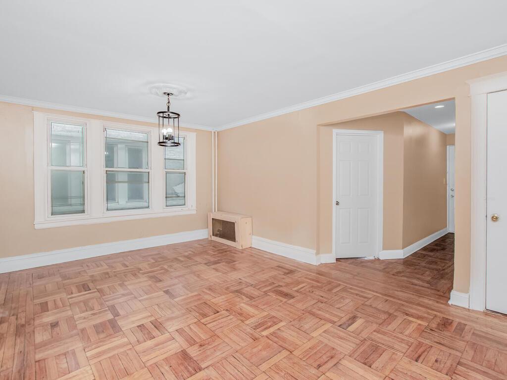 3357 Perry Avenue Bronx, NY 10467 - Photo 22 of 31 Empty room with crown molding and baseboards