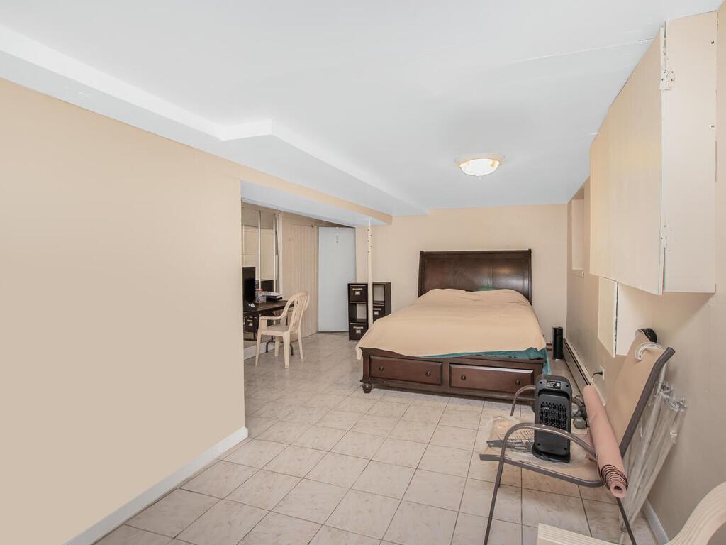 3357 Perry Avenue Bronx, NY 10467 - Photo 23 of 31 Bedroom featuring light tile patterned floors and baseboards