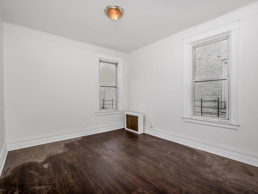3357 Perry Avenue Bronx, NY 10467 - Photo 3 of 31 Empty room featuring dark wood-style flooring and baseboards