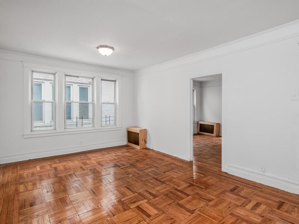 3357 Perry Avenue Bronx, NY 10467 - Photo 8 of 31 Spare room featuring baseboards and ornamental molding