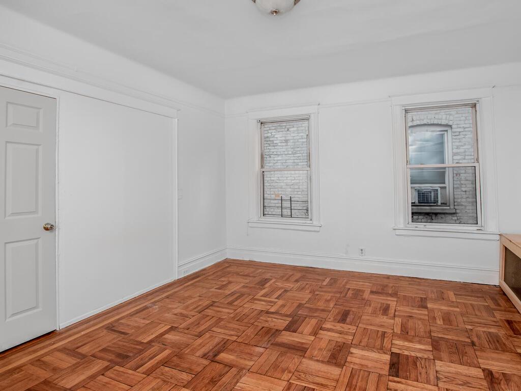 3357 Perry Avenue Bronx, NY 10467 - Photo 10 of 31 Empty room featuring baseboards and cooling unit