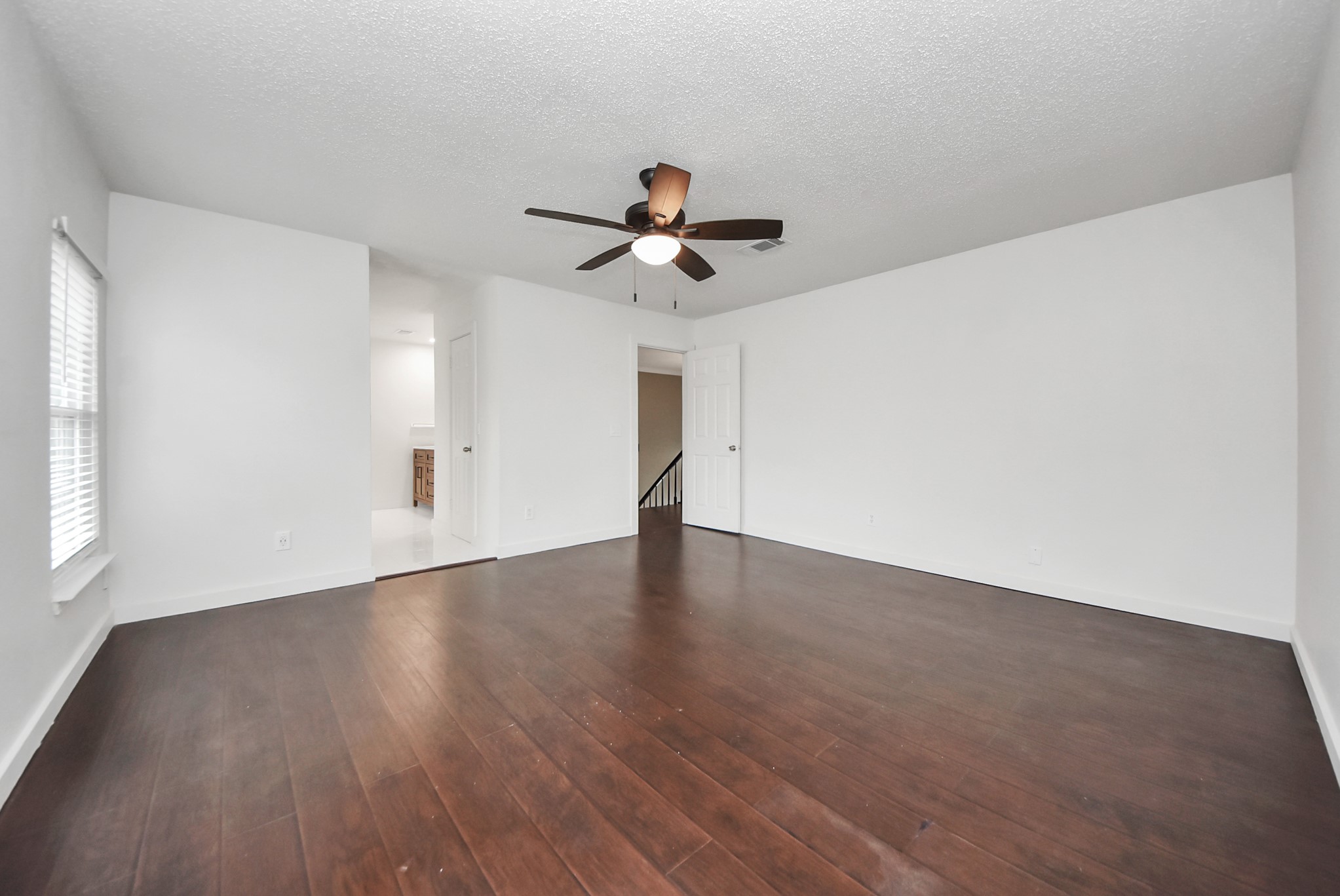12614 Mill Ridge Drive Cypress, TX 77429 - Photo 23 of 44 a view of a room with wooden floor ceiling fan and windows