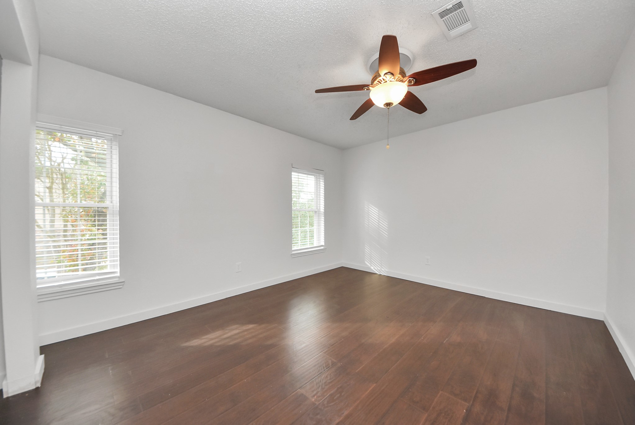 12614 Mill Ridge Drive Cypress, TX 77429 - Photo 25 of 44 a view of an empty room with wooden floor and a window