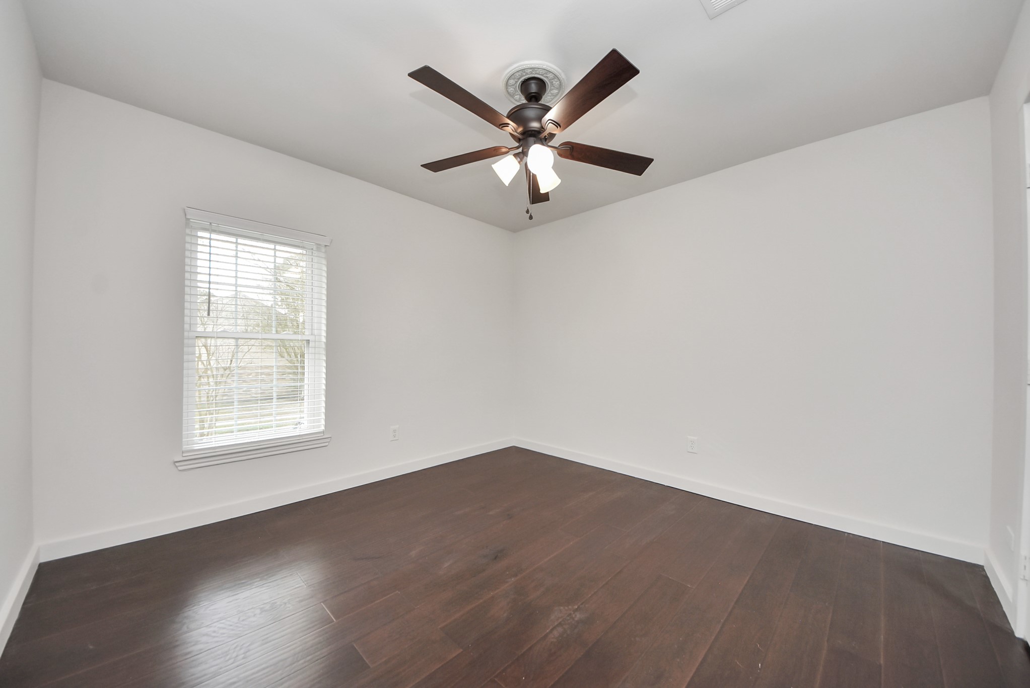 12614 Mill Ridge Drive Cypress, TX 77429 - Photo 27 of 44 an empty room with wooden floor fan and windows