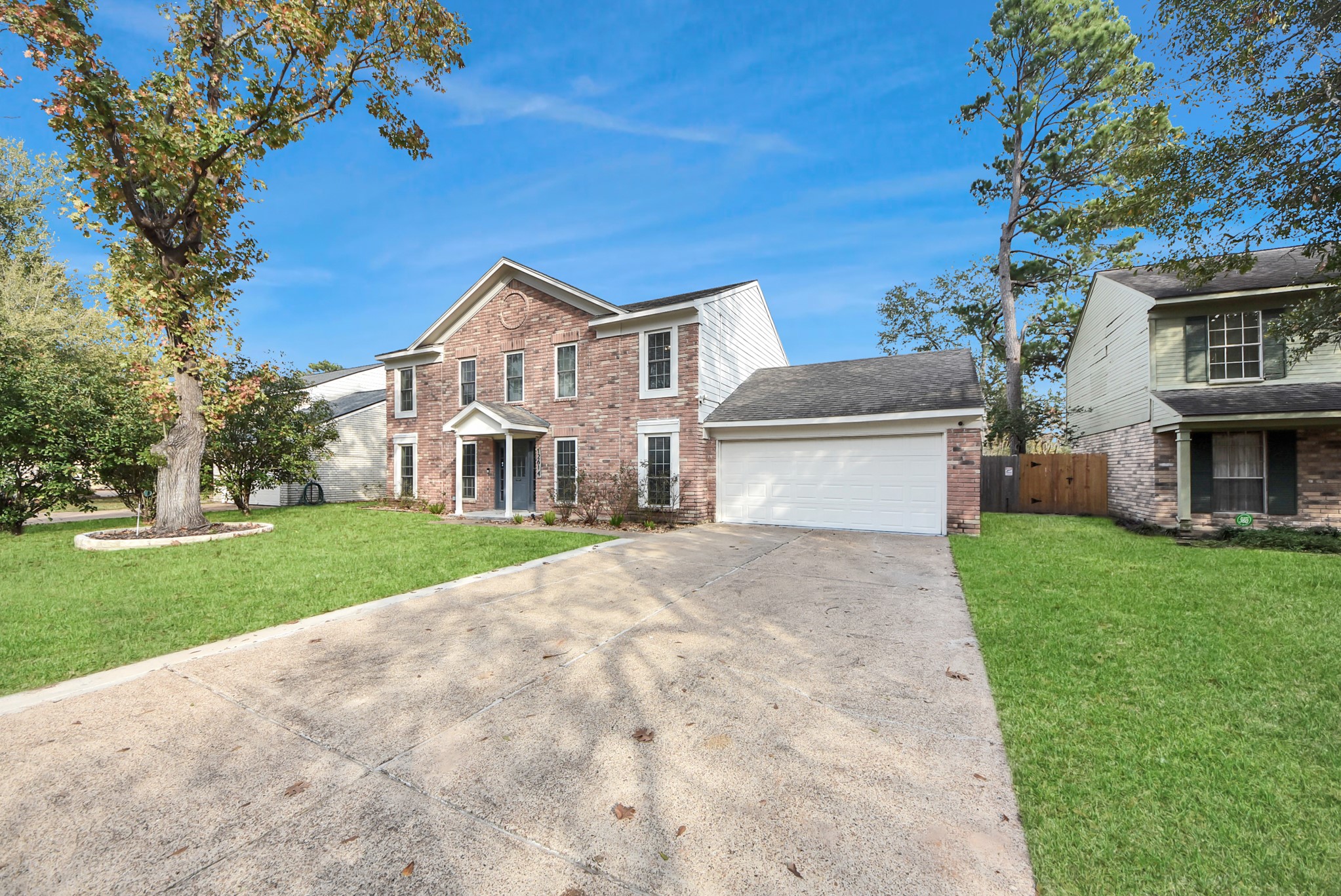 12614 Mill Ridge Drive Cypress, TX 77429 - Photo 3 of 44 a front view of a house with a garden and trees