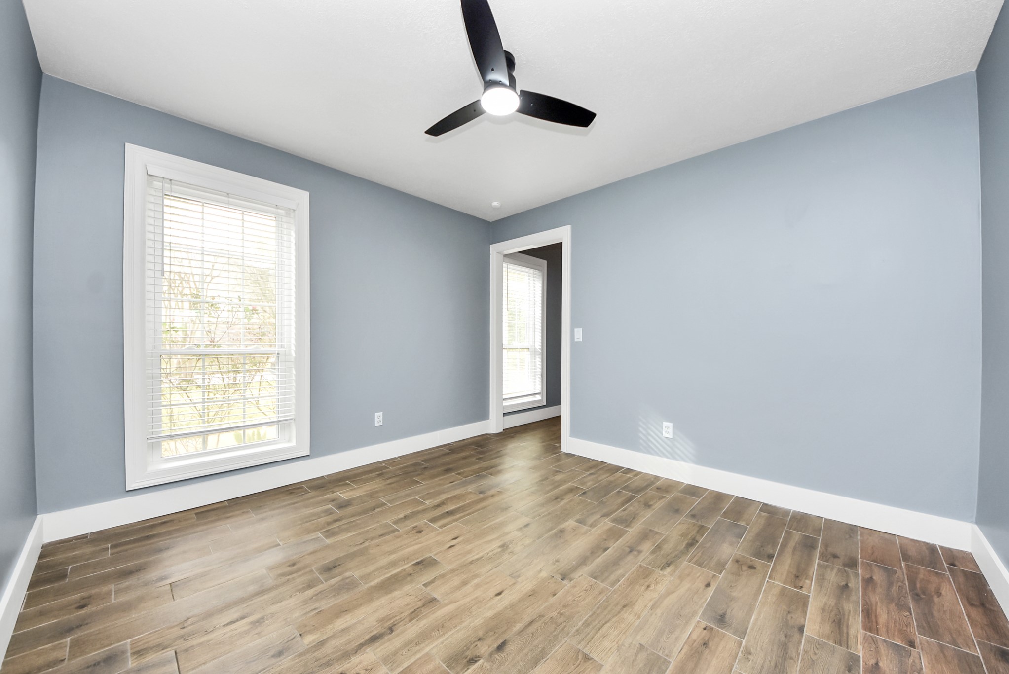 12614 Mill Ridge Drive Cypress, TX 77429 - Photo 6 of 44 wooden floor in an empty room with a window