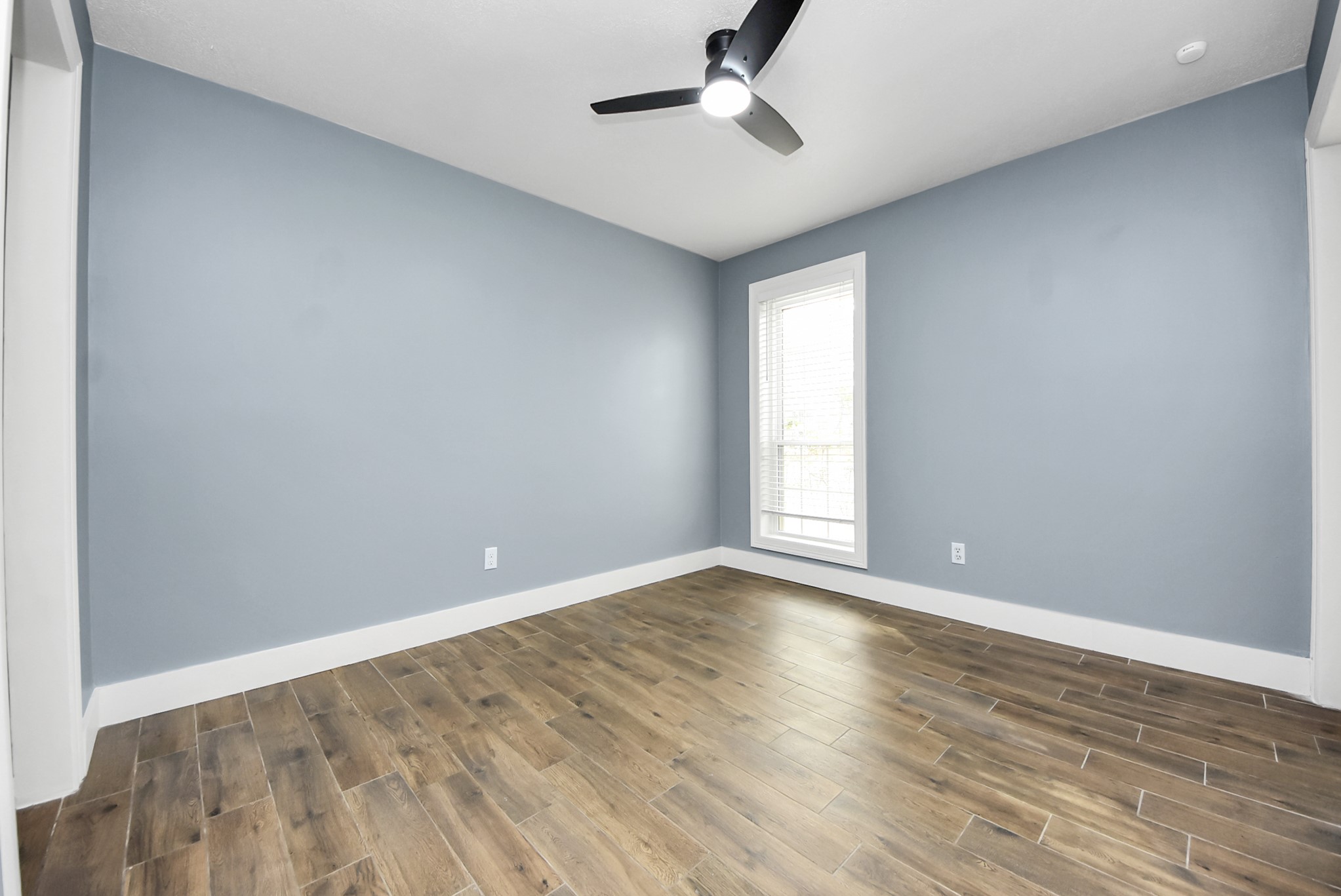 12614 Mill Ridge Drive Cypress, TX 77429 - Photo 7 of 44 wooden floor in an empty room with a window