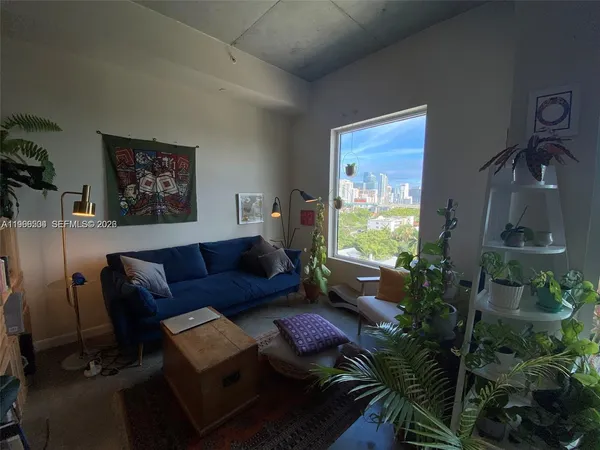 a living room with furniture a rug and a table
