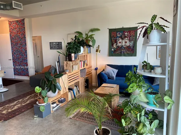 a living room with furniture and a rug