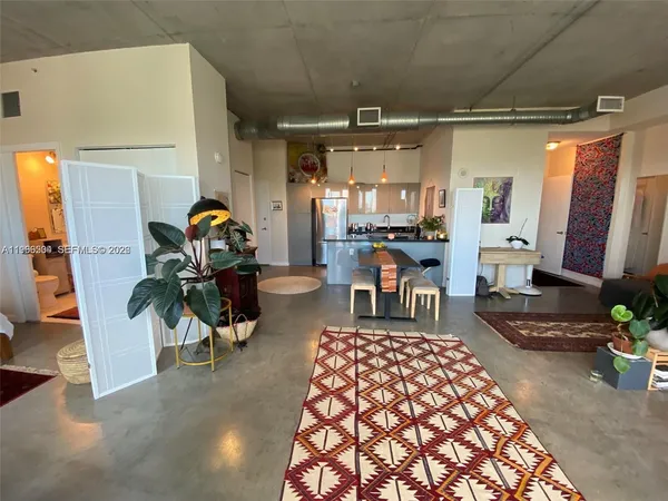 a room with furniture and a potted plant