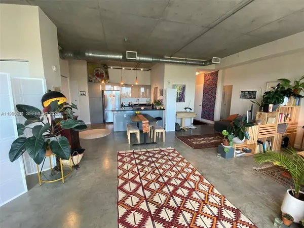 a bedroom with furniture and a potted plant