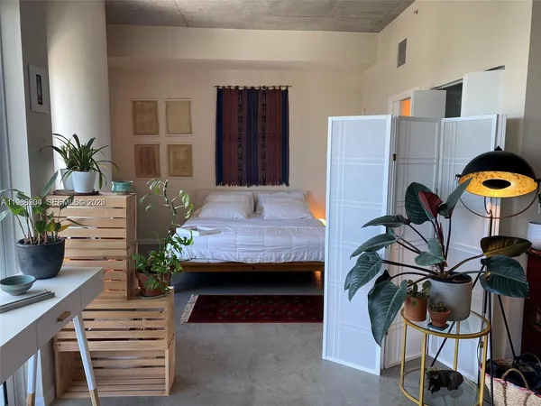 a room with furniture and potted plants