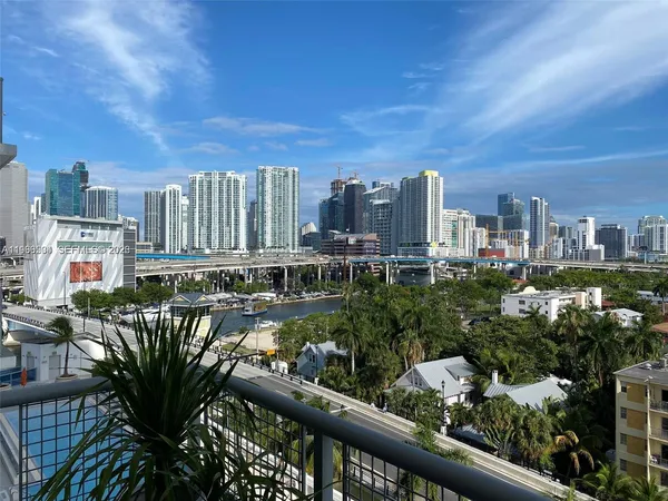 a view of a hallway with wooden floor and windows