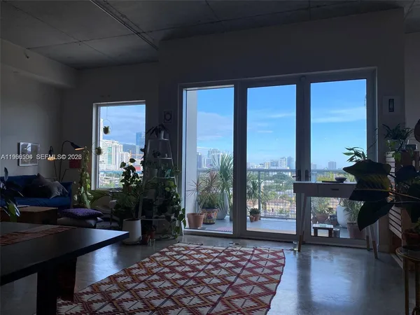 a living room with furniture and a large window