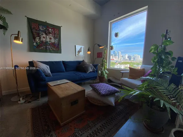 a living room with furniture and a potted plant