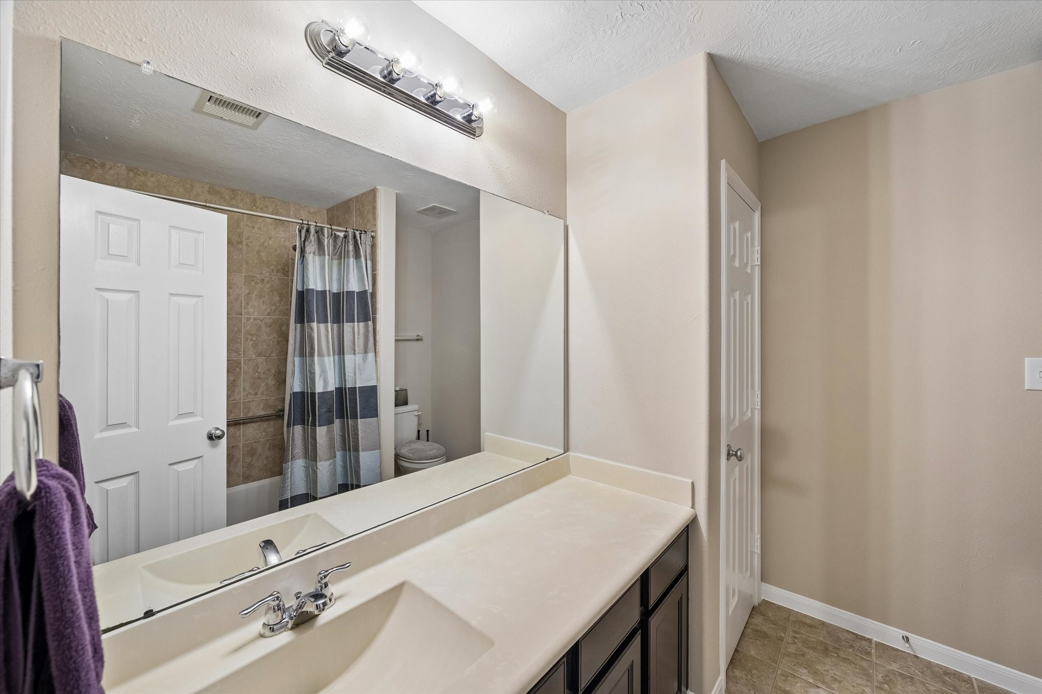 8433 Sunset Loch Drive Spring, TX 77379 - Photo 20 of 25 a bathroom with a sink and a mirror